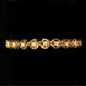 BRACELET - GOLD-TONE CHAIN with 25 CIRCLES WITH A RHINESTONE IN EACH CIRCLE.